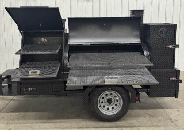 Black offset smoker SNS Barrel 60 catering trailer with multiple cooking chambers and slide out racks on single axle