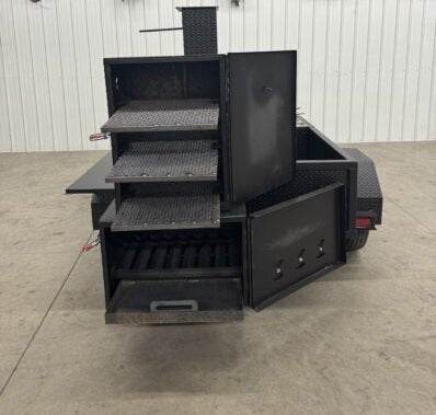 Offset smoker SNS Barrel 60 catering trailer with multiple slide-out cooking racks and reverse flow smoker design.