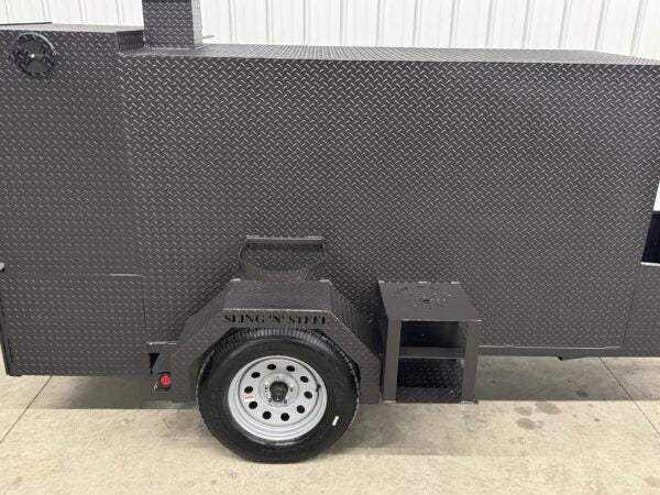 Box Smoker SNS Beast heavy-duty diamond tread steel cabinet smoker with insulated firebox and storage basket mounted on trailer wheelbase