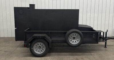 SNS Beast Cabinet wood smoker on trailer with full length storage and mounted spare tire in black steel design