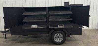 SNS Beast Cabinet Smoker with full-length storage, six slide-out cooking racks, insulated firebox, warming box, fish fryer, and large storage basket on trailer mount