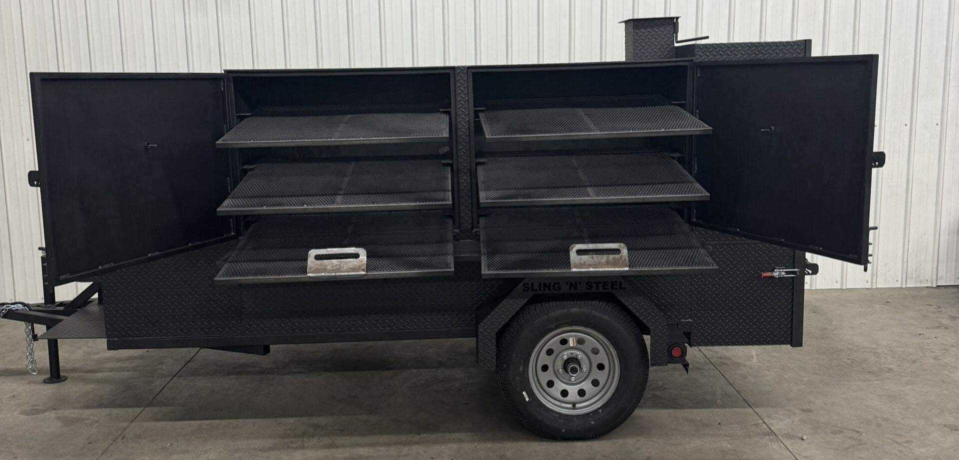 SNS Beast Cabinet Smoker trailer with six slide-out cooking racks and full-length storage compartments open on both sides