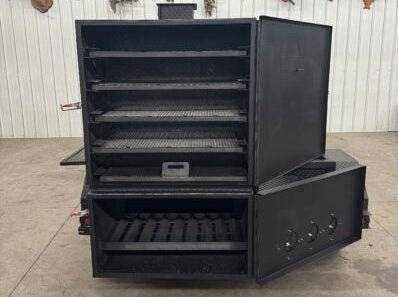 Large black SNS Beast Cabinet Smoker with full-length storage, multiple cooking racks, and insulated firebox for high-capacity smoking.