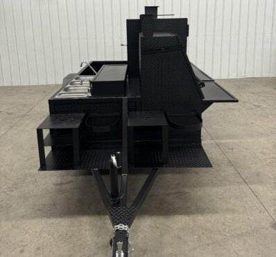 Black SNS Cabinet 60 BBQ Pit Catering Trailer with sink package and standard grill in warehouse setting
