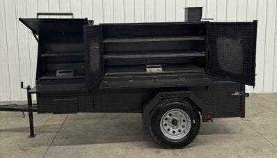 SNS Cabinet 60 Catering Trailer BBQ pit with sink package and multiple slide-out cooking racks on a single-axle trailer