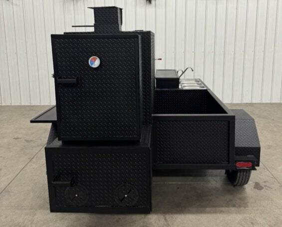 Heavy-duty black diamond tread steel BBQ pit with integrated sink and catering trailer setup