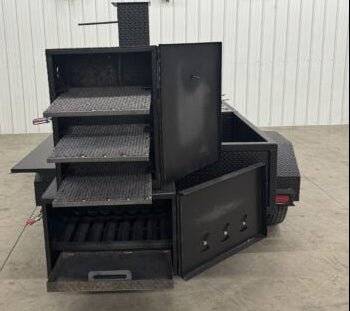 BBQ Pit SNS Cabinet 60 catering trailer with sink package and standard grill with multiple cooking racks and charcoal grill inside open doors