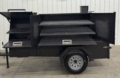 SNS Cabinet 60 Catering Trailer BBQ pit with three slide out cooking racks and insulated firebox on single axle trailer