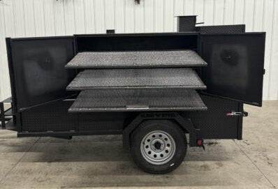 SNS Cabinet 60 Grill Smoker Combo with XL charcoal grill, three slide-out cooking racks, insulated firebox, rib box, and 3-bay sink package on trailer