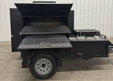 SNS Cabinet 60 Grill Smoker Combo with XL Grill and 3-Bay Sink Package on a trailer with multiple cooking racks and insulated firebox.