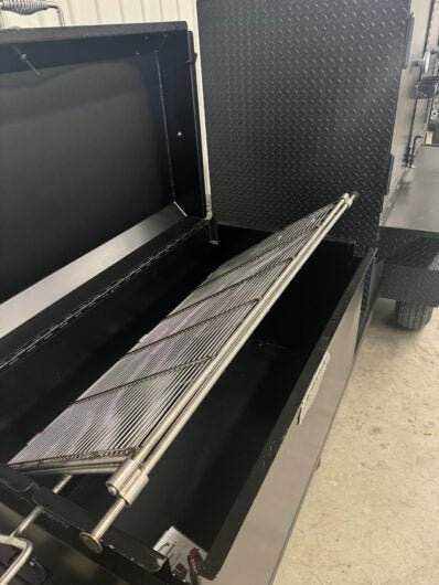 Wood fired smoker SNS Competition 60 cabinet with rotating stainless steel grate and charcoal pan inside black steel body