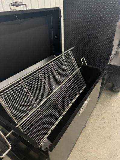 Wood fired smoker SNS Competition 60 cabinet with rotating stainless steel grate and charcoal pan inside black steel body