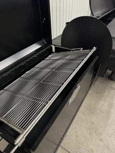 Commercial Custom Pits SNS Competition 60 smoker with 42-inch rotating stainless steel cooking rack and slide-out grates for BBQ catering
