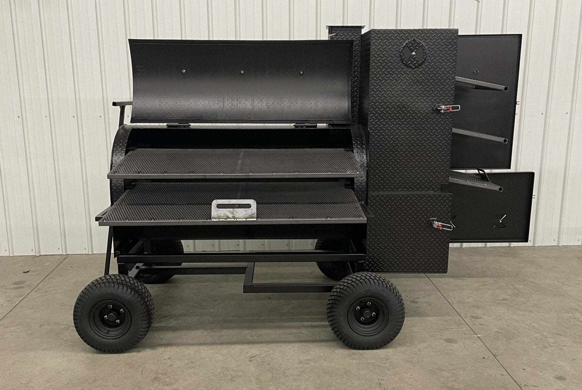SNS Competition Smoker large black steel wagon-style barbecue smoker with multiple cooking racks and insulated firebox on wheels