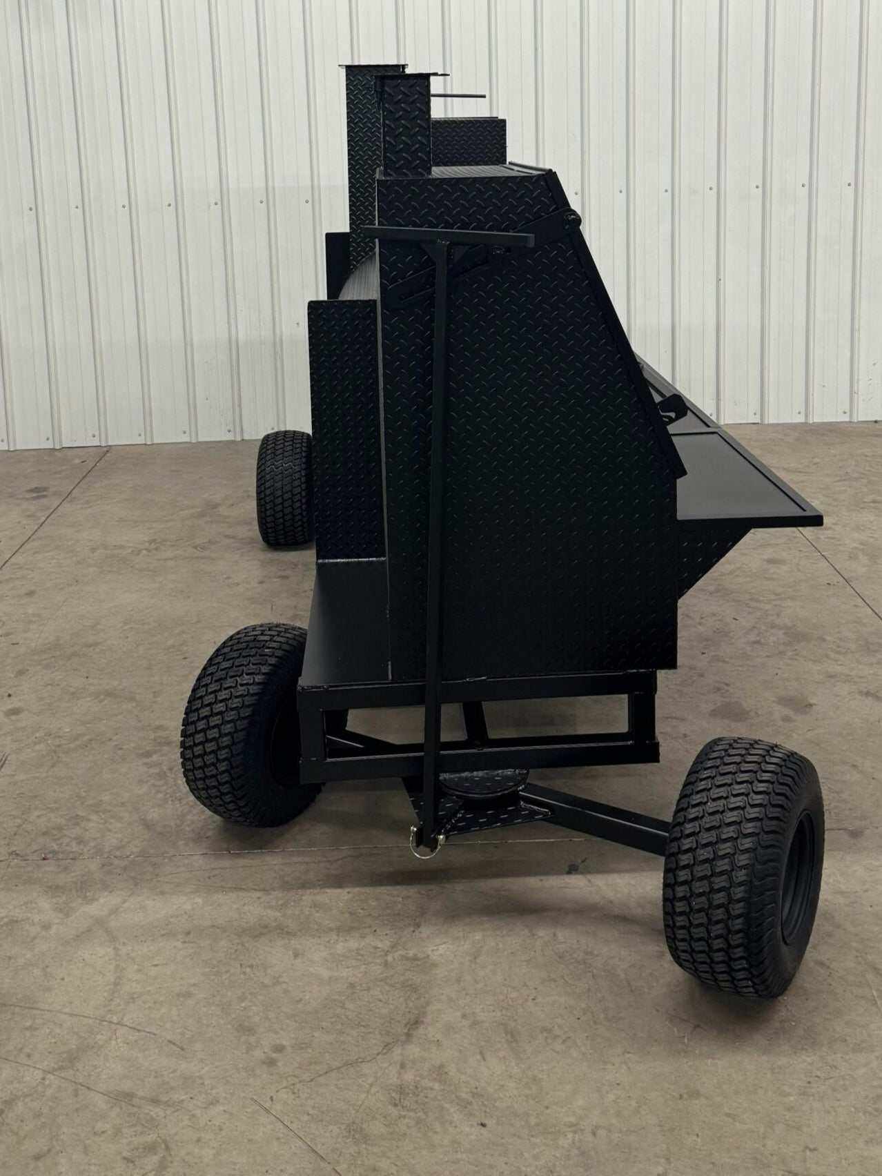 Black SNS Competition Wagon Backyard BBQ Smoker and Grill with diamond tread steel and large wheels for mobility