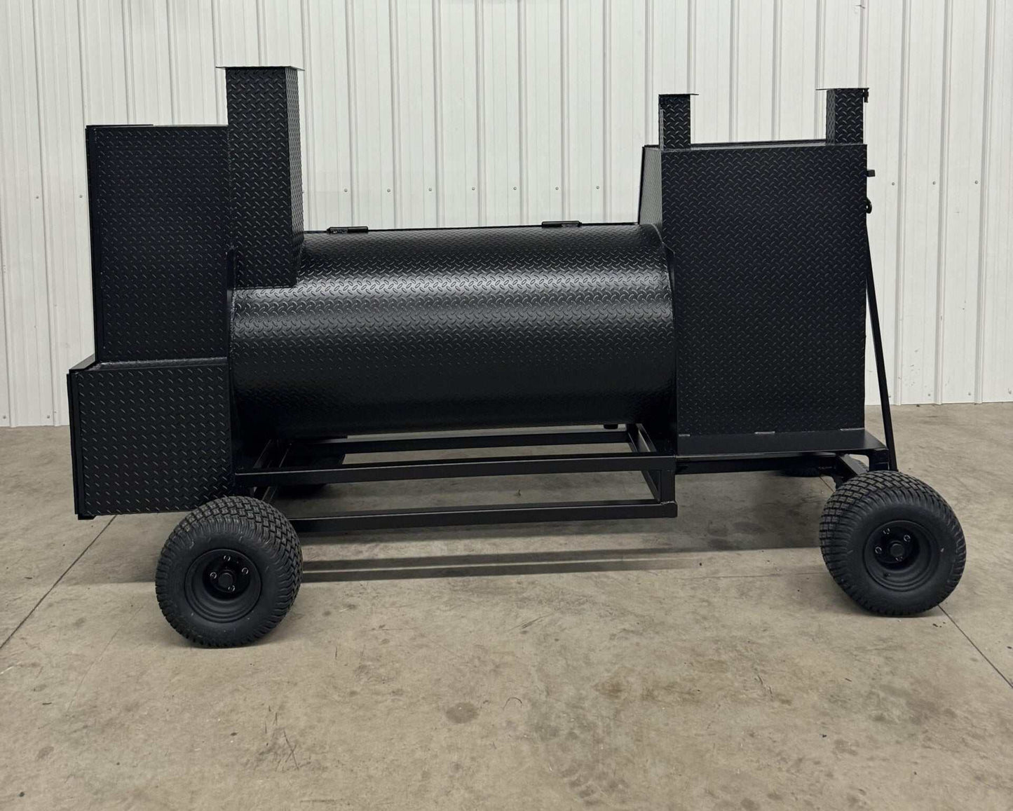 SNS Competition Wagon Smoker with grill made of 1/4 inch rolled diamond tread steel, featuring double-walled insulated firebox, rib/warming box, charcoal grill, and wagon chassis with pull handle for backyard BBQ.