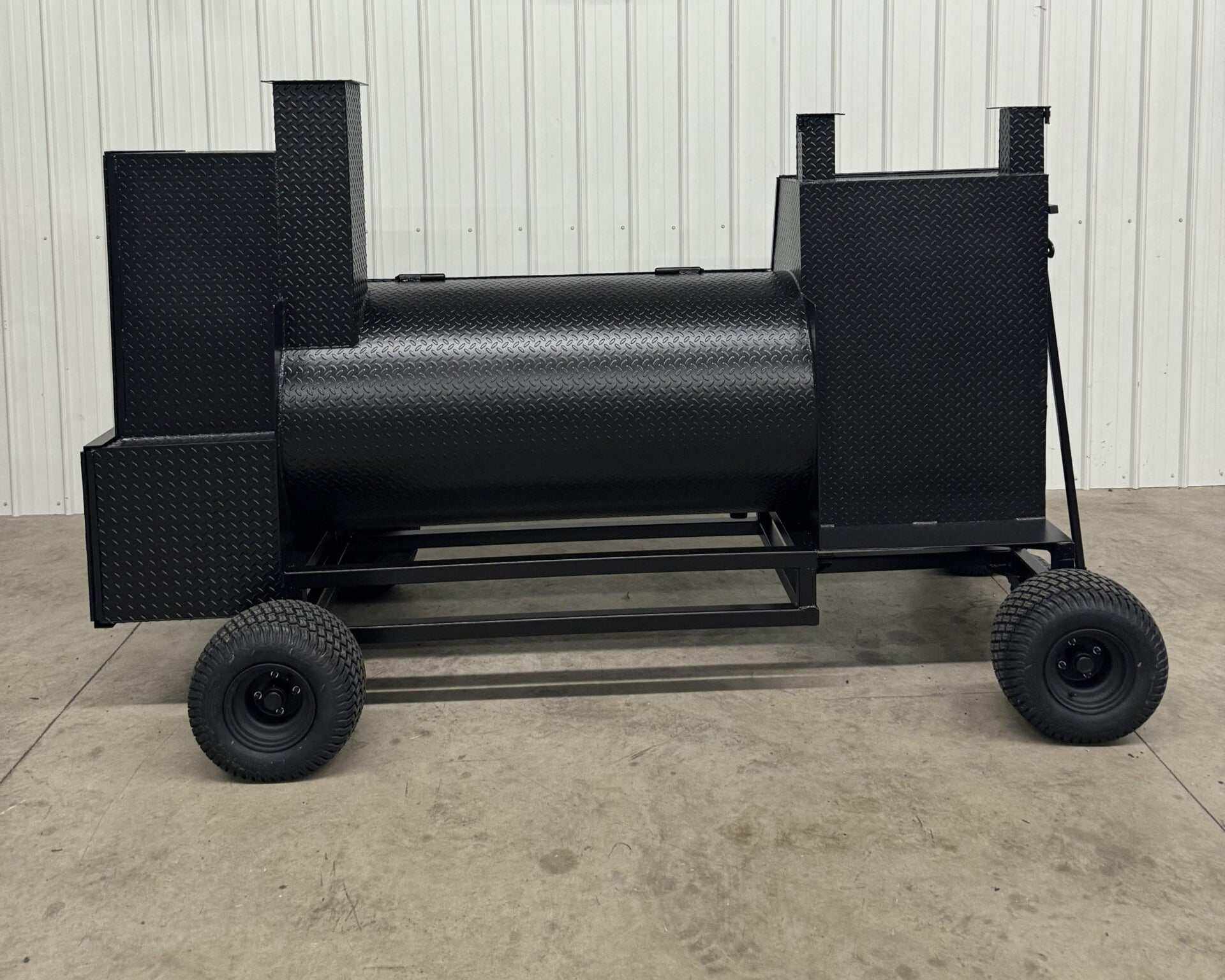 Black SNS Competition Wagon Backyard BBQ smoker with large cooking chambers and sturdy wheels for mobility