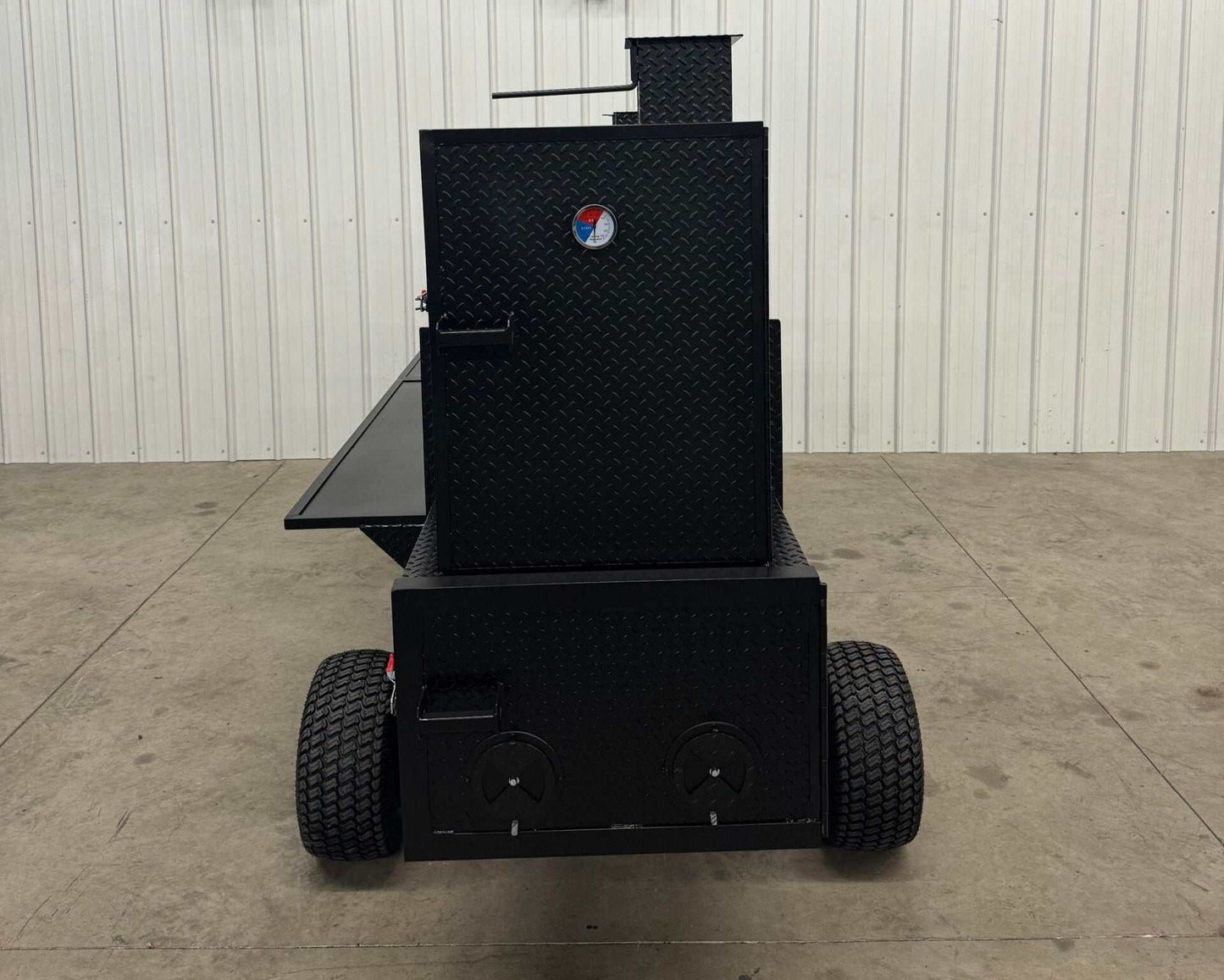 Black SNS Competition Wagon smoker with grill, diamond tread steel, large capacity backyard BBQ smoker on wheels with pull handle.