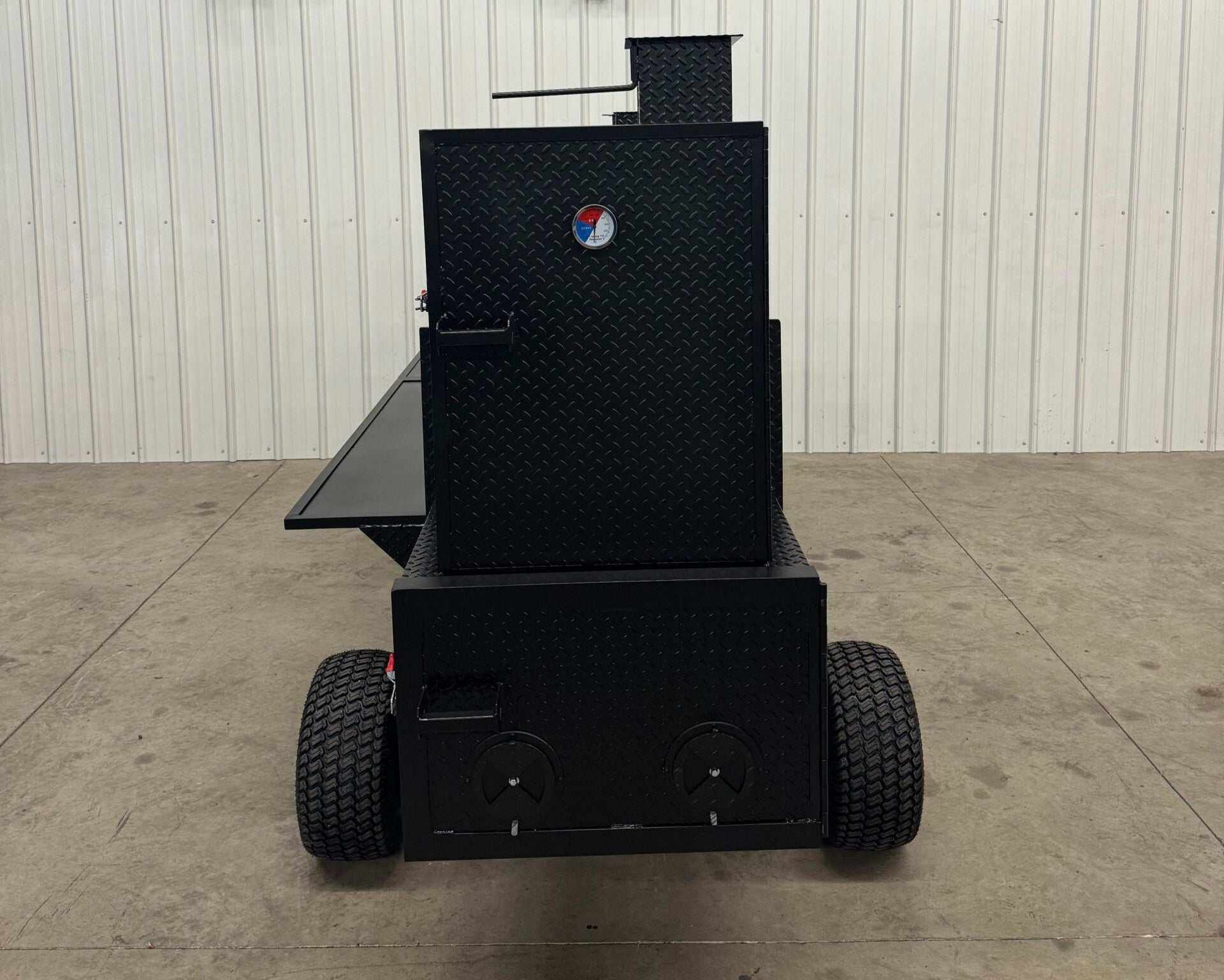 Black SNS Competition Wagon Backyard BBQ smoker with diamond tread steel, wheels, and pull handle designed for large capacity outdoor grilling and smoking.