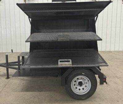 SNS Mega Grill commercial dual-pit grilling trailer with pull-out charcoal trays and cooking racks