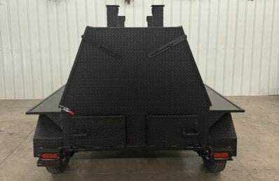 SNS Mega Grill grilling trailer with dual cooking pits and pull-out charcoal trays designed for commercial BBQ catering and outdoor cooking.