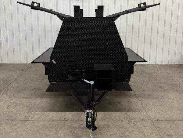 SNS Mega Grill commercial grilling trailer with dual charcoal cooking pits and pull-out trays shown from front view indoors