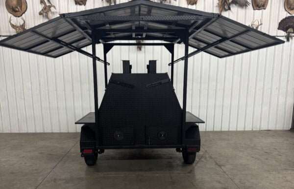 rear view of Giant SNS Mega Grill commercial catering trailer with roof and dual cooking pits