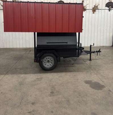 Commercial SNS Mega Grill with dual cooking pits and red roof on a trailer for BBQ catering