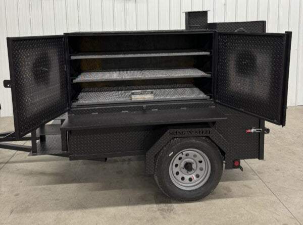 SNS Smoke House Smoke Cabinet Smoker with open double doors showing three grilling racks on a trailer with diamond plate steel construction and a single wheel.