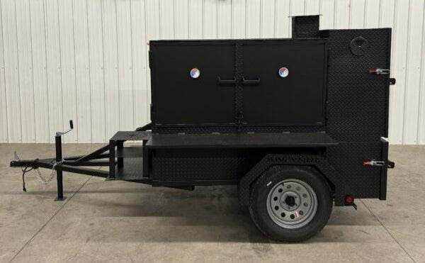 SNS Smoke House Smoke Cabinet smoker trailer with large main chamber, flat grill, warming box, and diamond plate steel finish