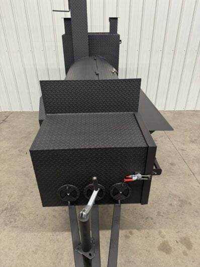 SNS Tailgater 60 trailer smoker and grill with diamond tread steel barrel, charcoal grill, and multiple slide-out cooking racks for large capacity BBQ cooking.