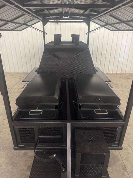 SNS Ultimate Mega Grill charcoal trailer with two-sided main chamber, pull-out charcoal trays, rotating racks, and heat-resistant black matte finish under roof package