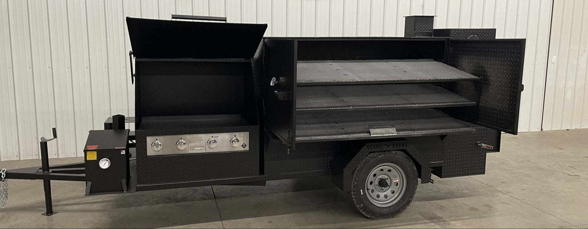 SNS Ultimate Smokehouse 60-inch charcoal grill smoker with 36-inch griddle, triple cooking racks, warming box, sink, and dual basket fryer.