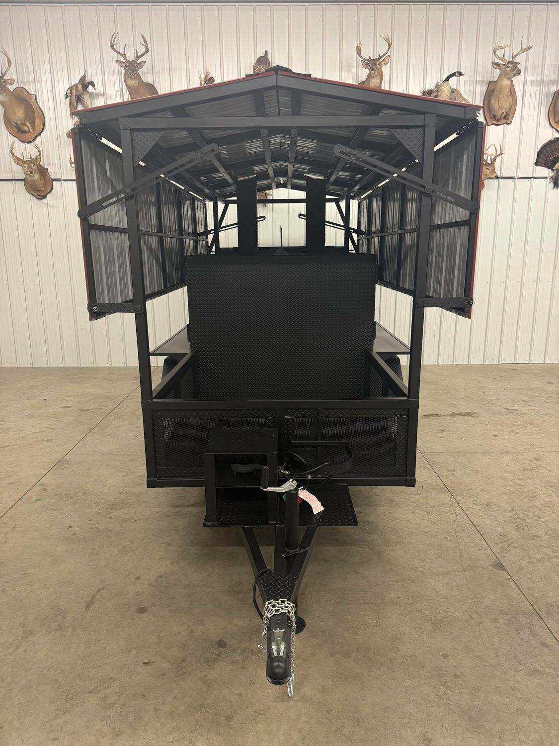 large black commercial smoker Avery with multiple cooking racks and trailer hitch for catering and restaurant use