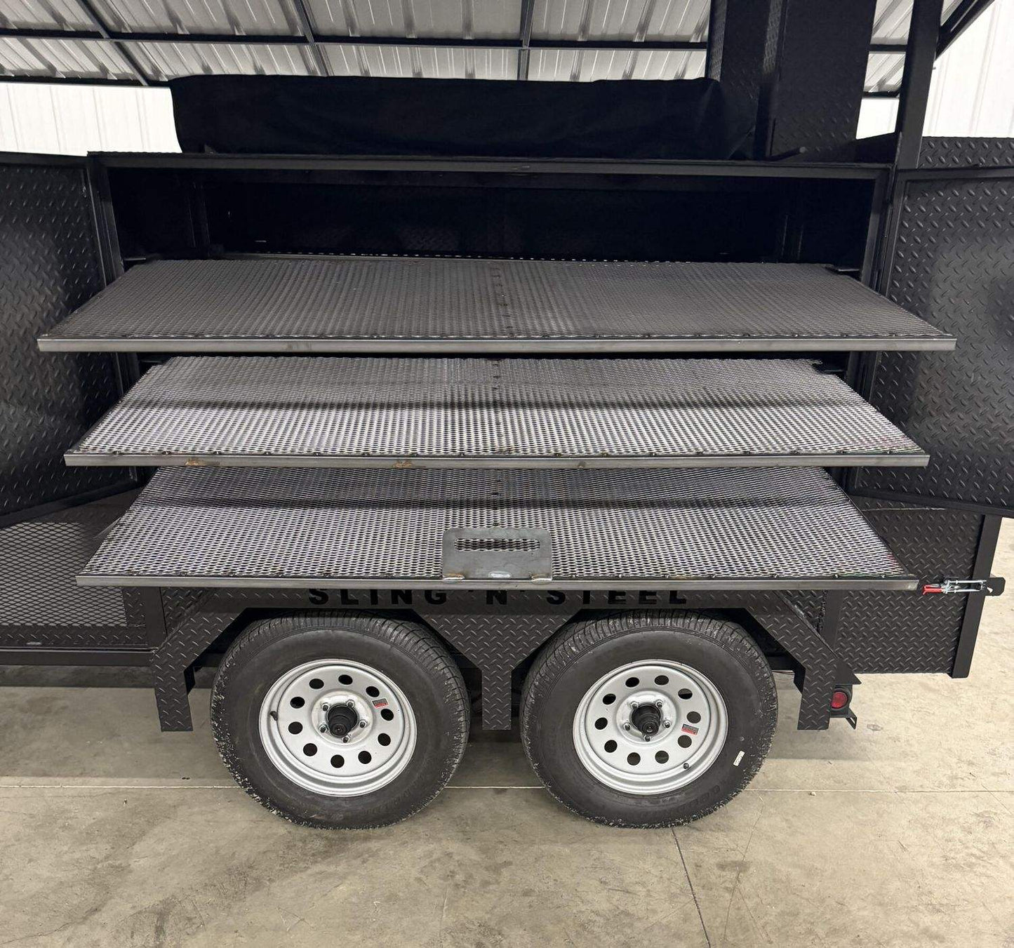 Commercial Avery smoker with large cooking chamber, multiple racks, steel wheels, and heavy-duty construction for catering and restaurant use.