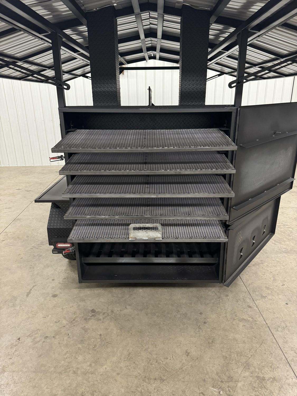 Commercial Avery Cabinet Smoker with multiple cooking racks, large cooking chamber, and insulated double-walled firebox designed for commercial use.