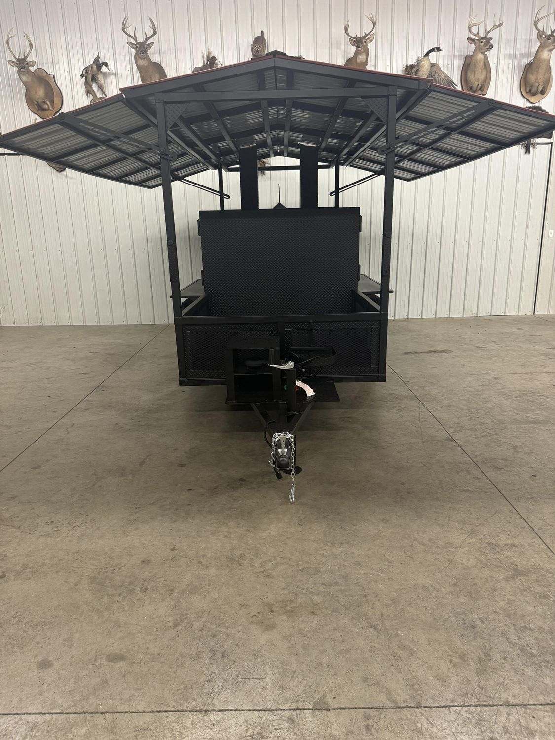 commercial Avery cabinet smoker with large roof and steel frame in indoor setting