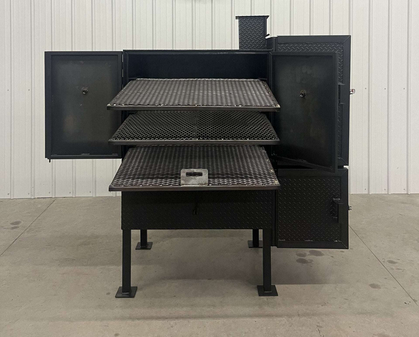 SNS 40 smoker cabinet with large 30x40 main chamber, three racks, double-walled insulated firebox, and reverse flow design.