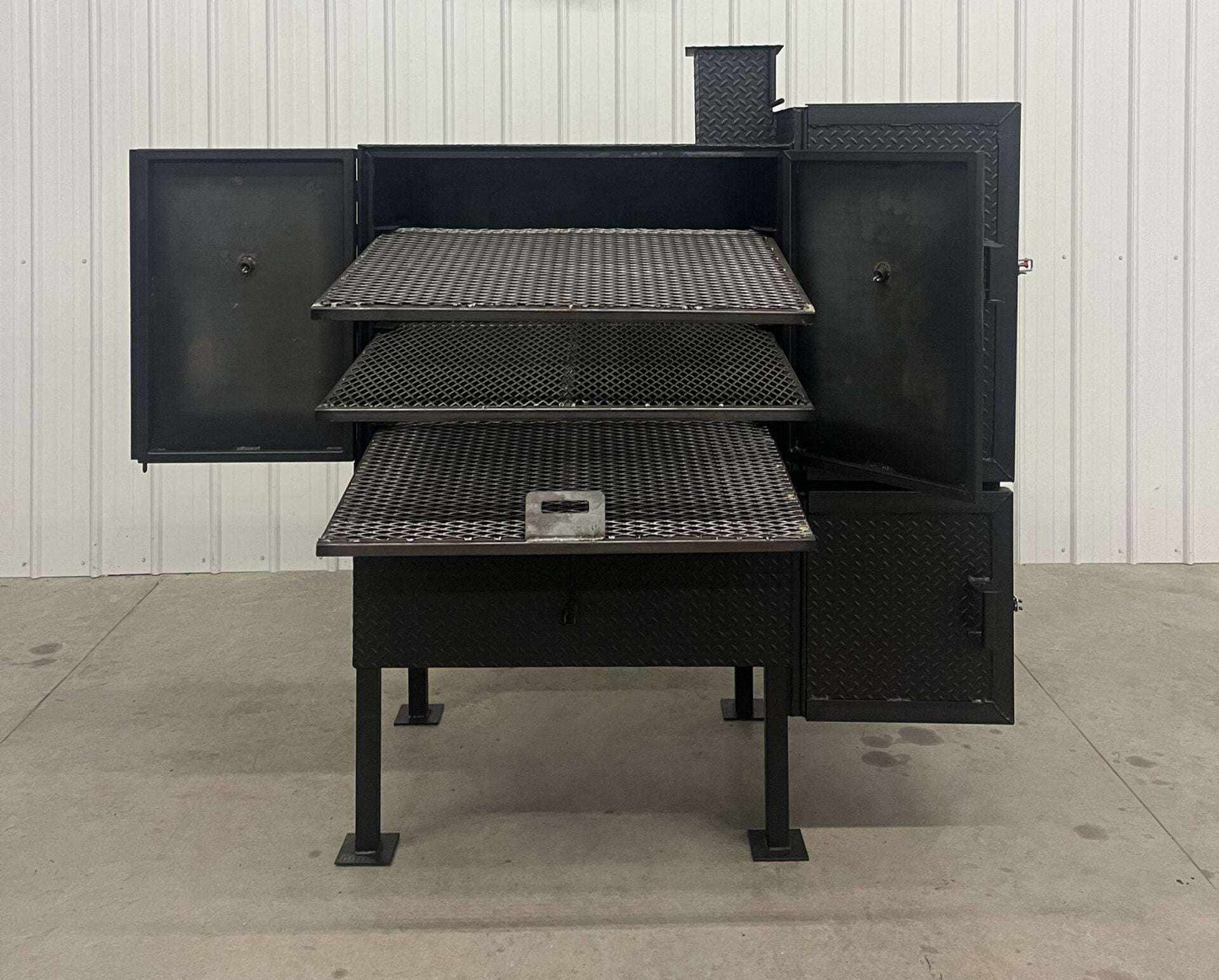SNS 40 Smoker Cabinet with large 30x40 chamber, three racks, and double-walled insulated firebox designed for heavy-duty smoking and patio use.