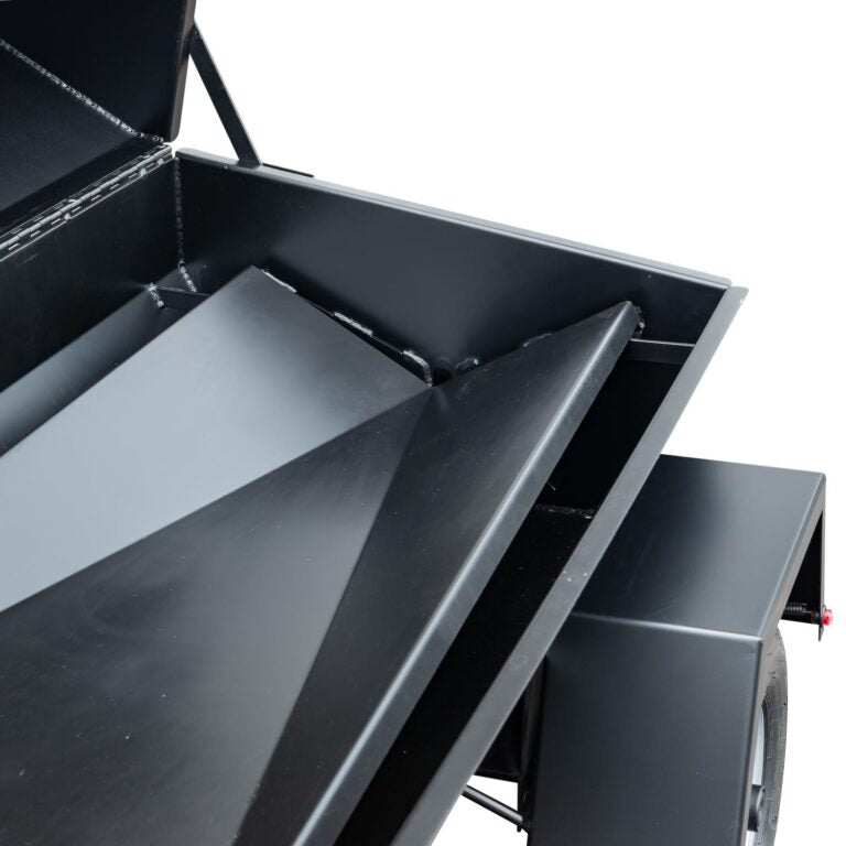 Black metal trailer with open cargo bed on a white background