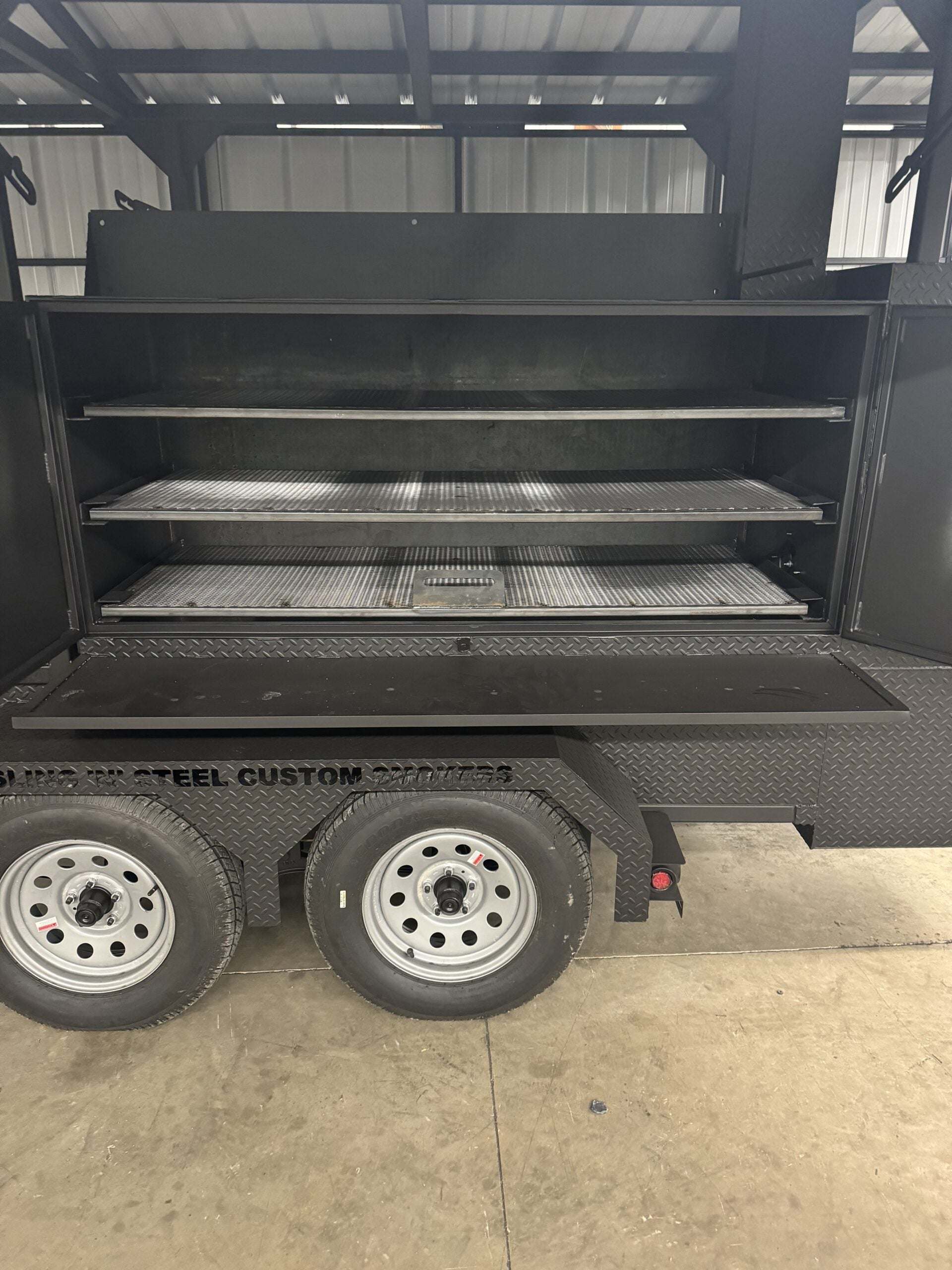 Commercial Smoker Custom Ultimate Smokehouse 72-inch reverse flow smoker with three pull-out cooking racks and charcoal grill on trailer