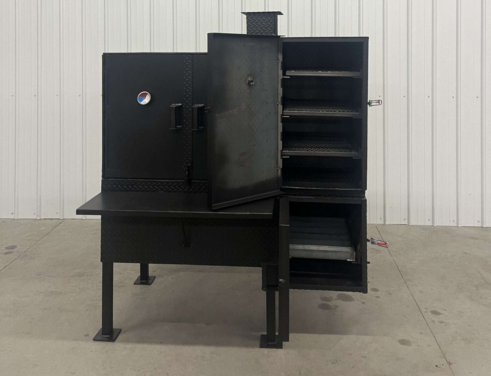SNS 40 Cabinet vertical smoker with large chamber, three racks, double-walled insulated firebox, and heavy-duty build for patio or trailer use