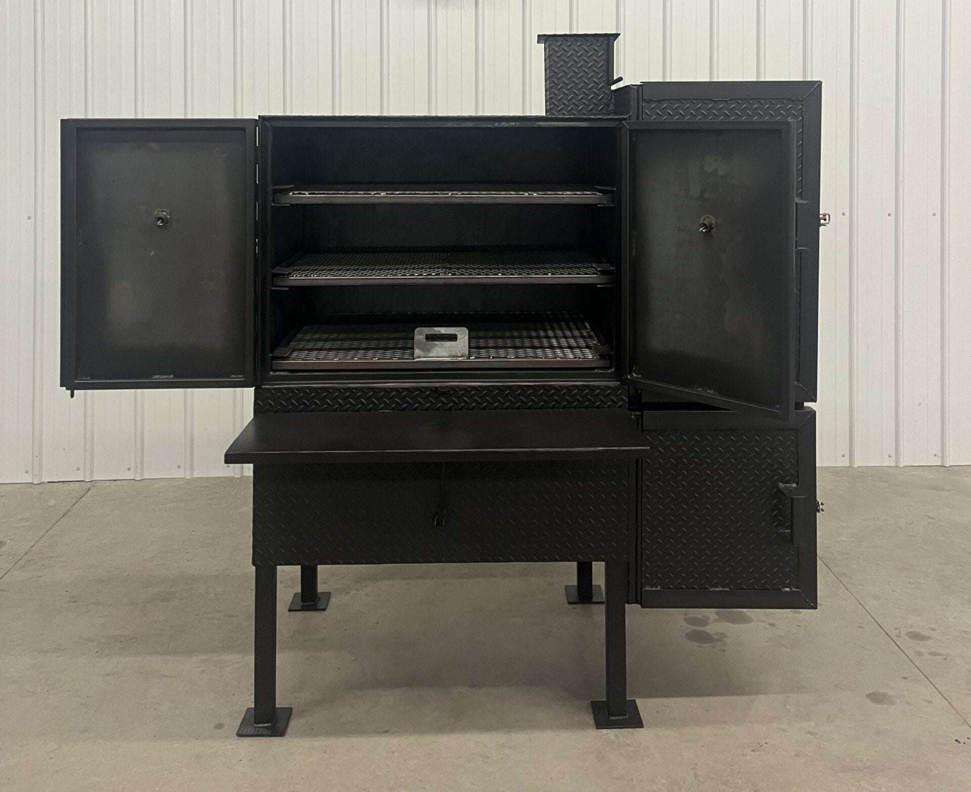 SNS 40 Cabinet vertical smoker with open doors, three racks, and heavy-duty build for large capacity smoking.