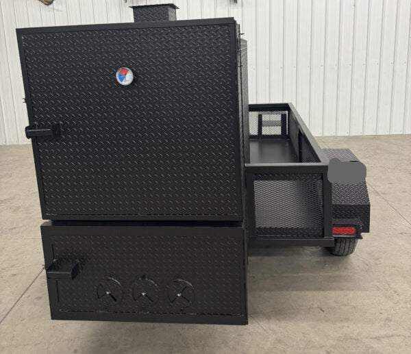 Black SNS 4060 smoker grill with cabinet main chamber made of 1/4 inch diamond tread steel on trailer frame