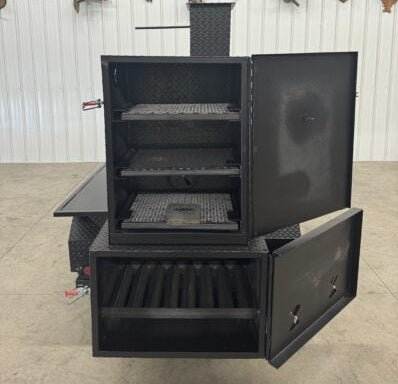 Black SNS Barrel 60 reverse flow smoker with charcoal grill showing open cooking racks and insulated firebox doors in an indoor setting