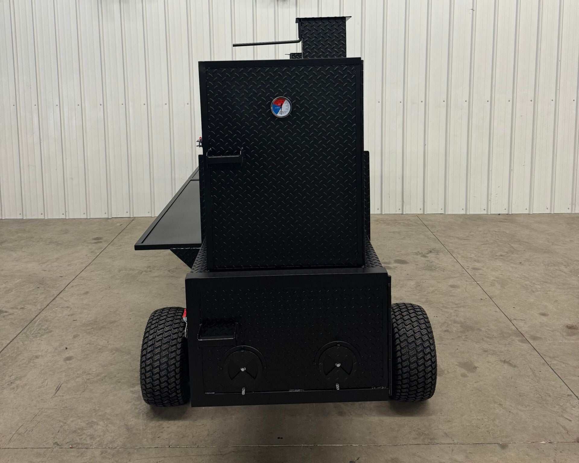Black SNS Competition Wagon smoker with grill, diamond tread steel, large capacity backyard BBQ smoker on wheels with pull handle.