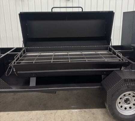 SNS Hospitality BBQ Trailer with large propane gas grill and dual-tier cooking grates for whole pigs, pork butts, ribs, briskets, chickens, and hamburgers.