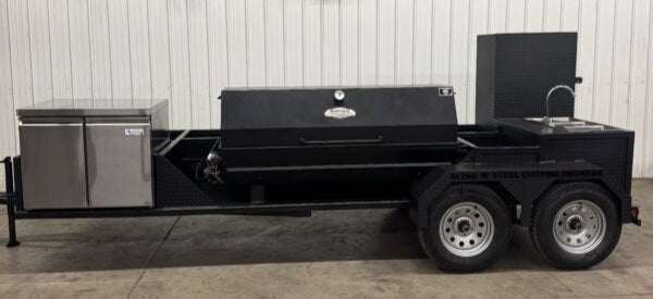 SNS Hospitality BBQ Trailer with propane grill, refrigerator, sink, and storage compartments designed for large-scale cooking and events